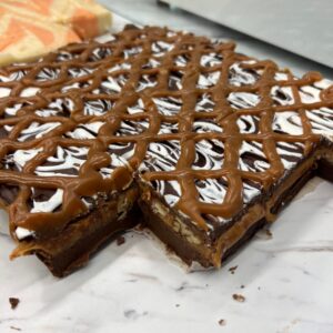 TorTush (Turtle) Fudge – Chocolate fudge with a gooey caramel nut center and white chocolate/ caramel topping